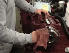 Vacuum repair technician cleaning and servicing a vacuum motor in Lakewood, CO
